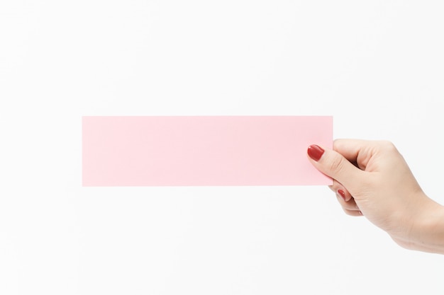 Close up women holding pink blank paper on white background