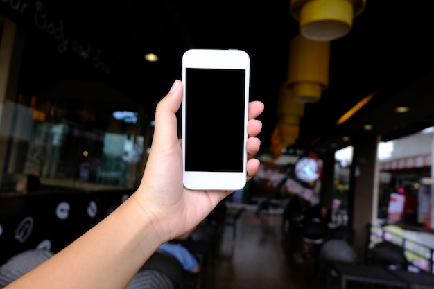 Close up of women's hands holding cell telephone blank copy space screen. smart phone with technology concept.