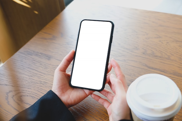 Close up of women's hands holding cell telephone with blank copy space screen