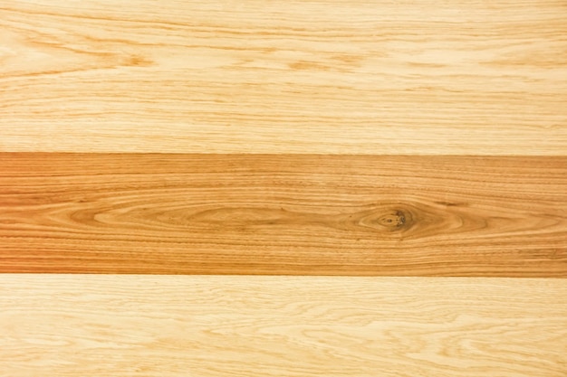 A close up of a wood plank with a dark brown stripe.