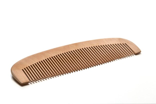 Photo close-up of wooden comb on white background