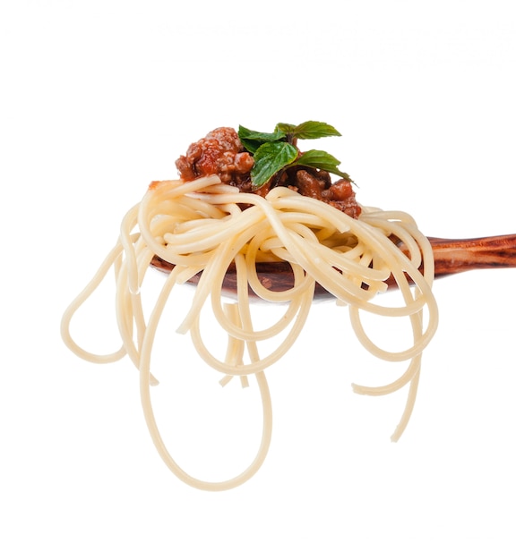 Close up of wooden cooking spoon with homemade traditional Italian pasta 