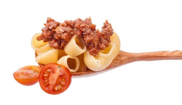 Close up of wooden cooking spoon with homemade traditional Italian pasta 