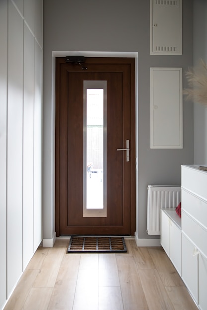 Photo close-up of a wooden door in the hallway in the style of minimalism.