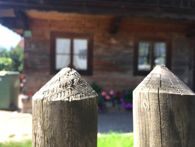 Close-up of wooden fence against house