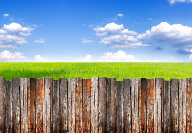 Close-up of wooden fence on field against sky