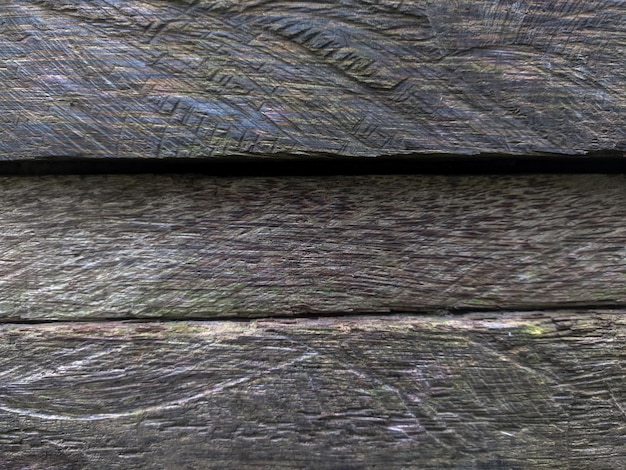 A close up of a wooden fence with a wooden fence in the background.