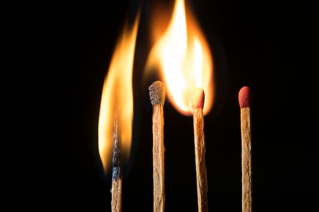 Close-up of wooden match lighting up. Shot in studio