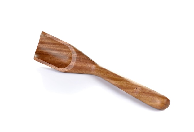 Close-up of wooden measuring spoon against white background