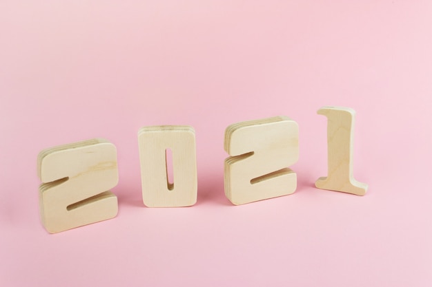 Close-Up Of Wooden Number 2021 pink Table. Idea of merry christmas and happy new year 2021 holiday