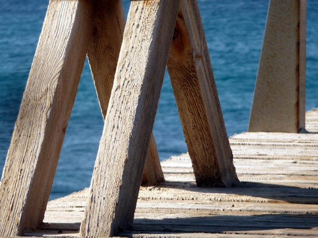 Foto prossimo piano di pali di legno sulla spiaggia