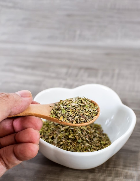 Close up of wooden spoon with oregano