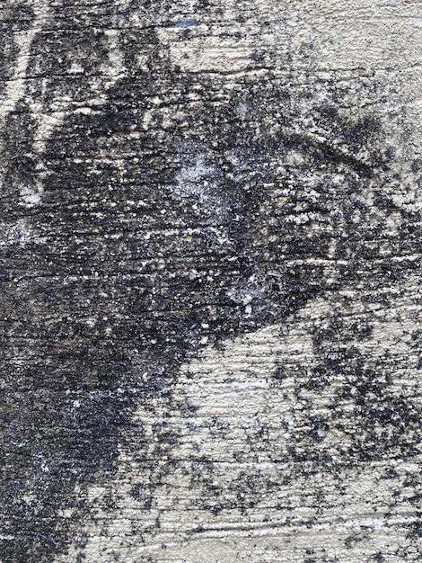 A close up of a wooden surface with a black and white pattern.