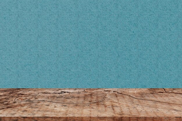 Photo close-up of wooden table against turquoise wall