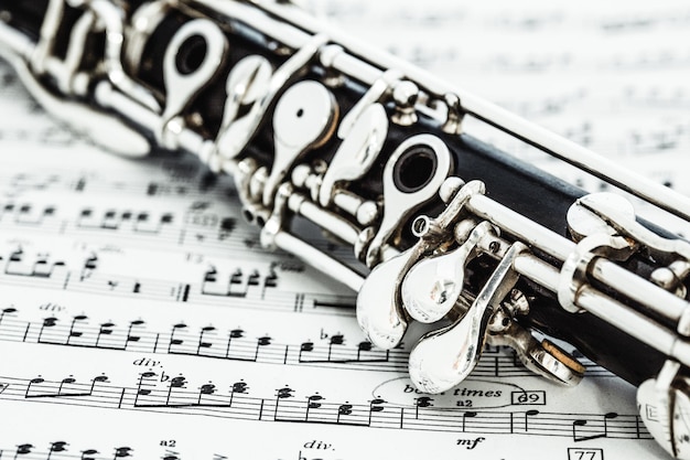 Photo close-up of woodwind instrument on sheet music