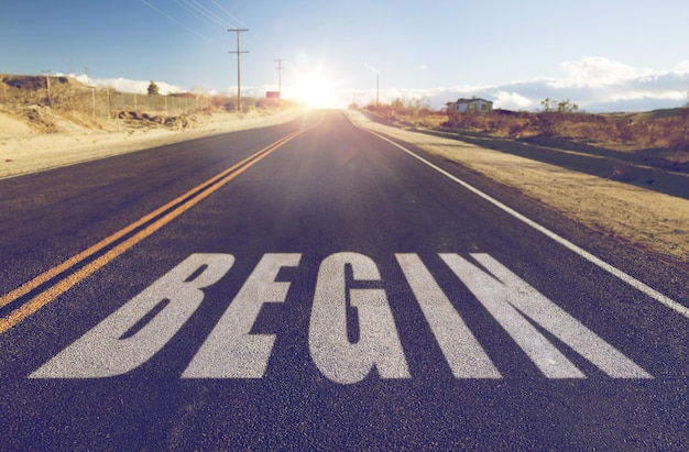 Photo close up of word begin on suburban asphalt road