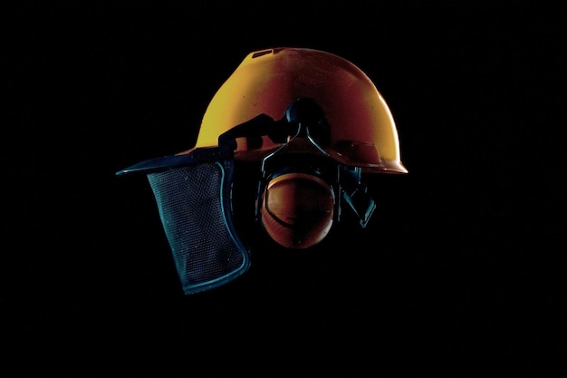 Photo close-up of work helmet against black background