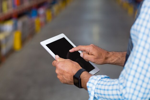 Close up of worker hands using a tablet