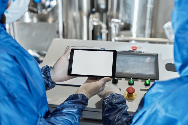 Close up of worker holding digital tablet with white screen mockup