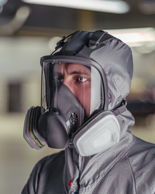 Close up on worker in overalls and a protective mask