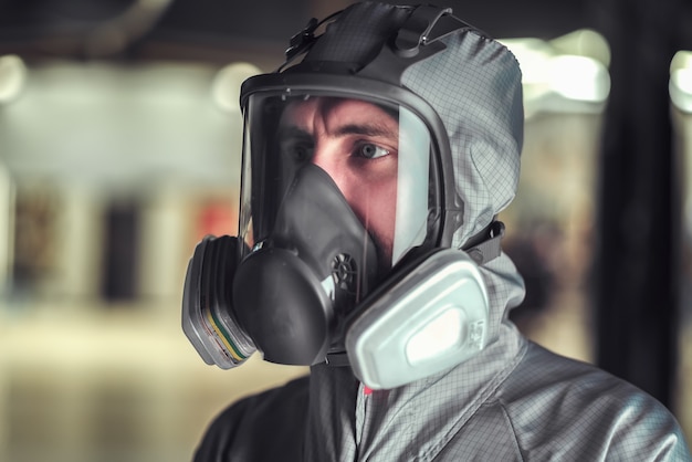 Close up on worker in overalls and a protective mask