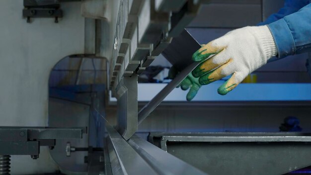 Close up of worker pressing metal at workshop creative sheet metal hydraulic cnc press brake machine