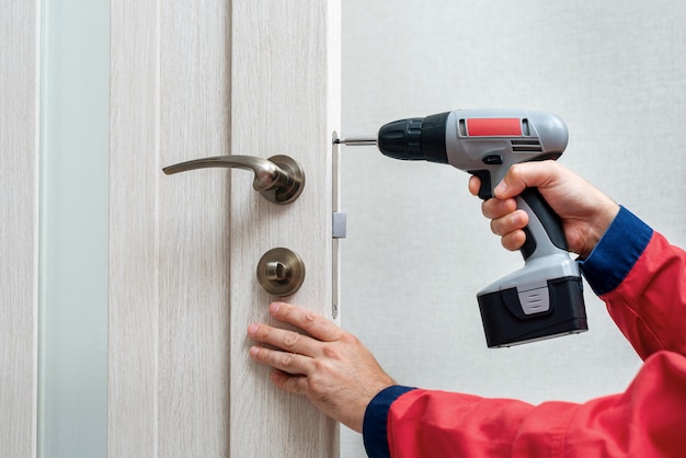 Close up worker's hand with screwdriver mounting lock