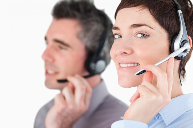 Close up of workers speaking through headsets