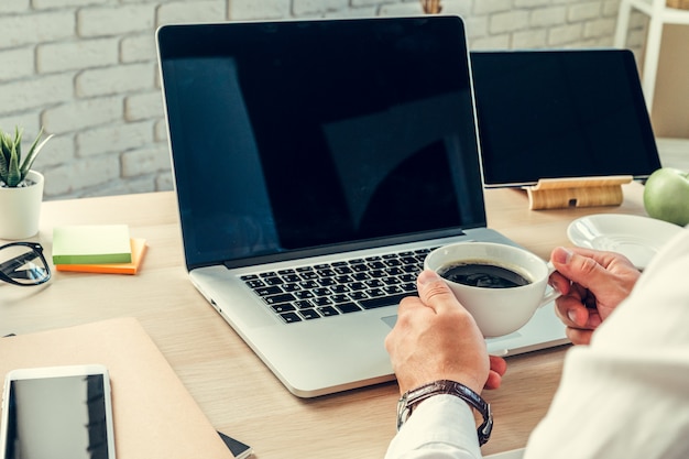 Close up of a working table of a businessman with laptop