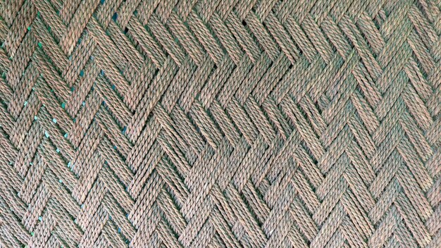 A close up of a woven rug with a blue and green pattern.