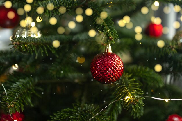 Close up of xmas balls on christmas tree bokeh garlands in the background new year concept high