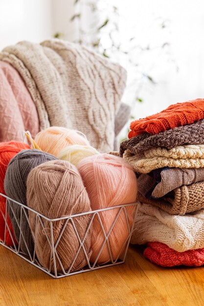 Close up of yarn balls at the basket concept of knitiing hobby