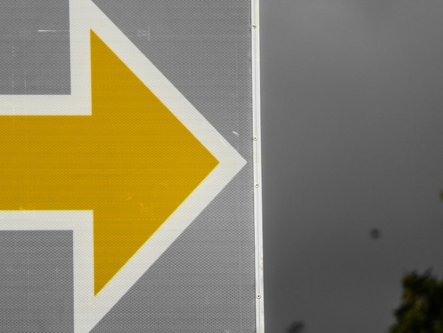 Close-up of yellow arrow symbol