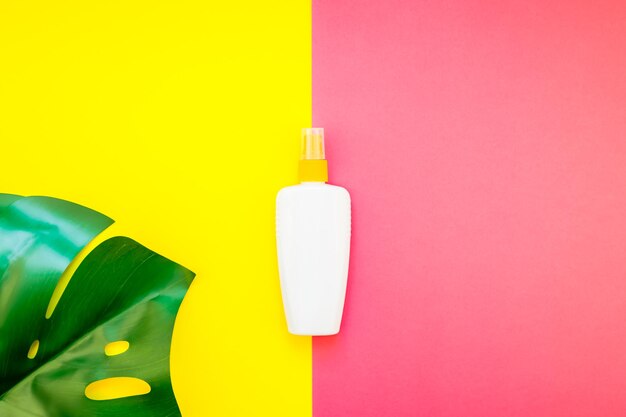 Close-up of yellow bottle against pink background