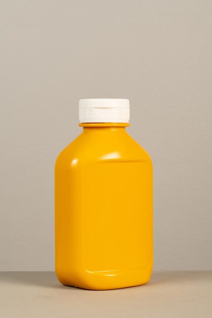 Close-up of yellow bottle against white background