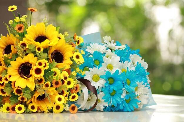 Close-up of yellow daisy flowers on table