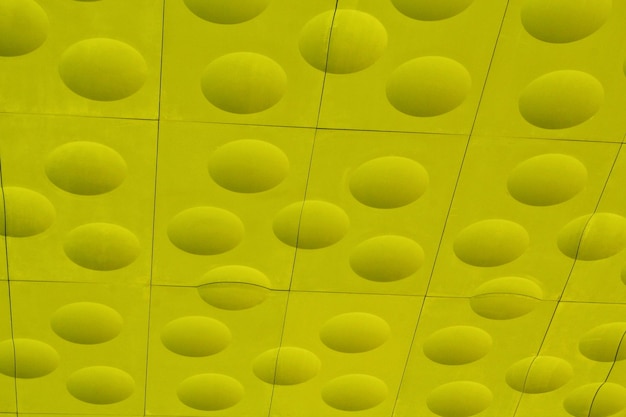 The close-up of yellow detailed sphere texture reverse side of the plastic tile. Rough embossed latt