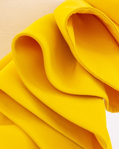 A close up of a yellow fabric with the word