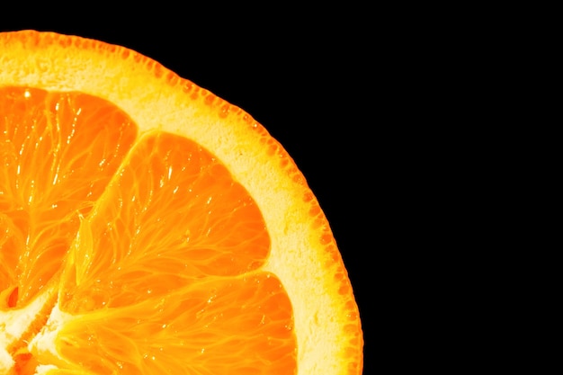 Close-up of yellow fibers of an orange standing on black background