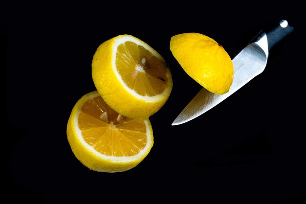 Photo close-up of yellow fruits on table against black background