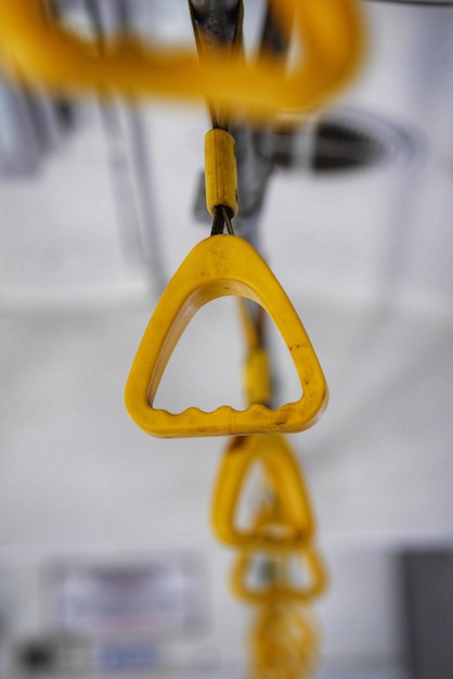 Close-up of yellow light bulbs hanging on metal