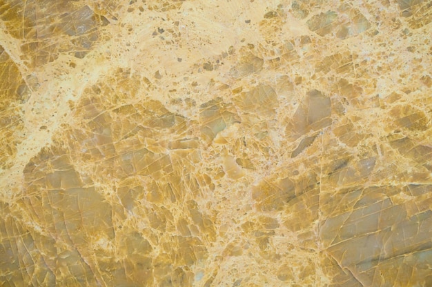 黄色の大理石の織り目加工の背景のクローズアップ