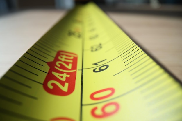 Photo close up of yellow metal measure tape wide angle image of measure tape