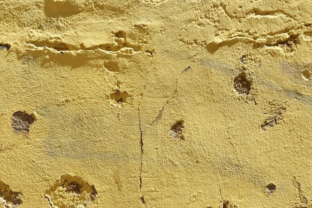 Photo close up of a yellow mortar wall