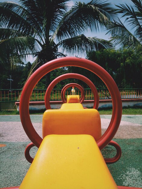 Close-up of yellow playground equipment trees in park