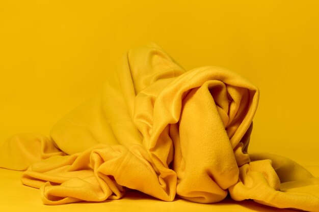 Close-up of yellow rose against orange background