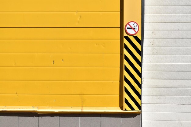 Close-up of yellow sign on wall