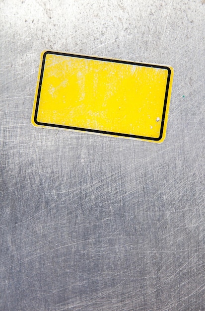 Close-up of yellow sticker on metal