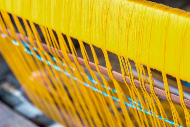 Close-up of yellow threads on machinery
