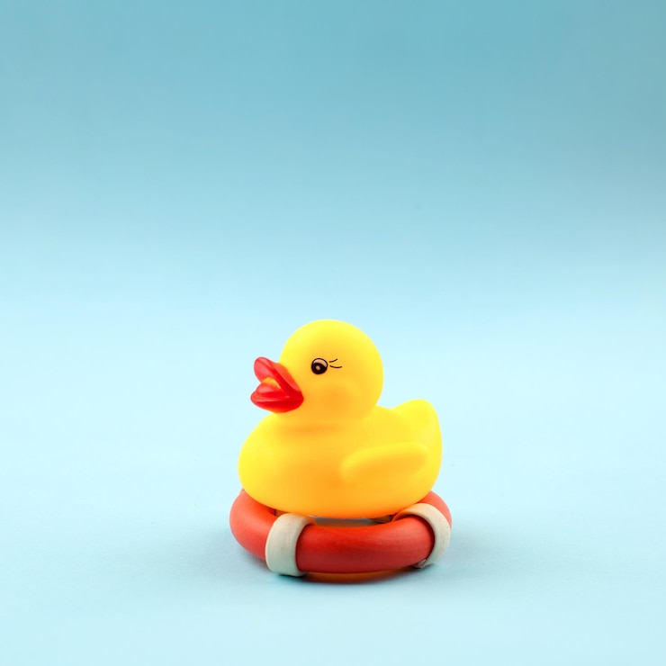 Photo close-up of yellow toy over blue background